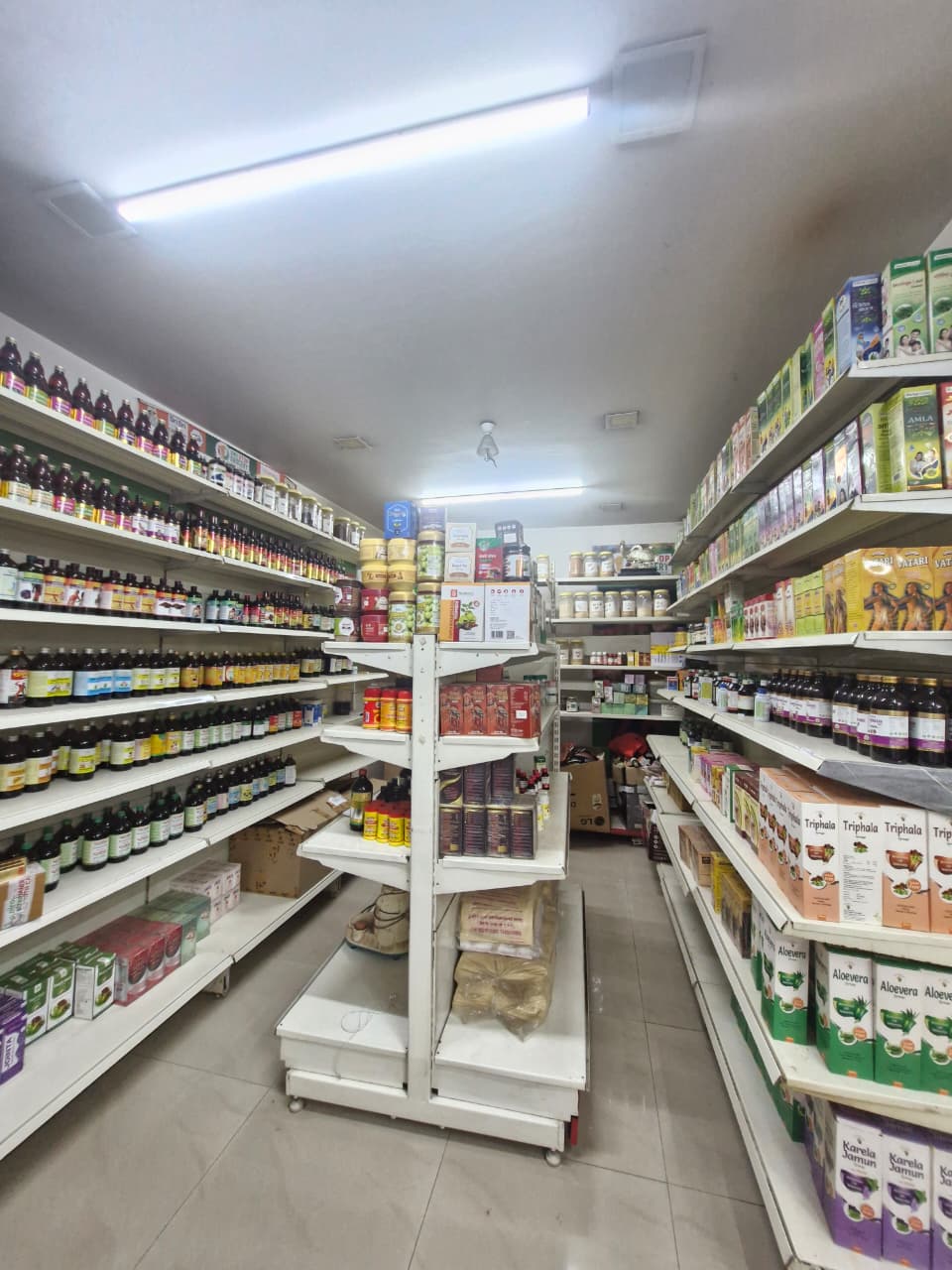 Ayurvedic medicine shelves stocked inside the clinic